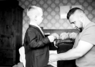 Dad helping son put suit on